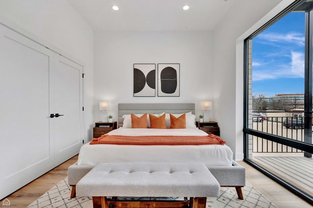 1616 West Hastings Street, Unit 101 Chicago, IL 60608 - Photo 10 of 19 a bedroom with a bed and wooden floor