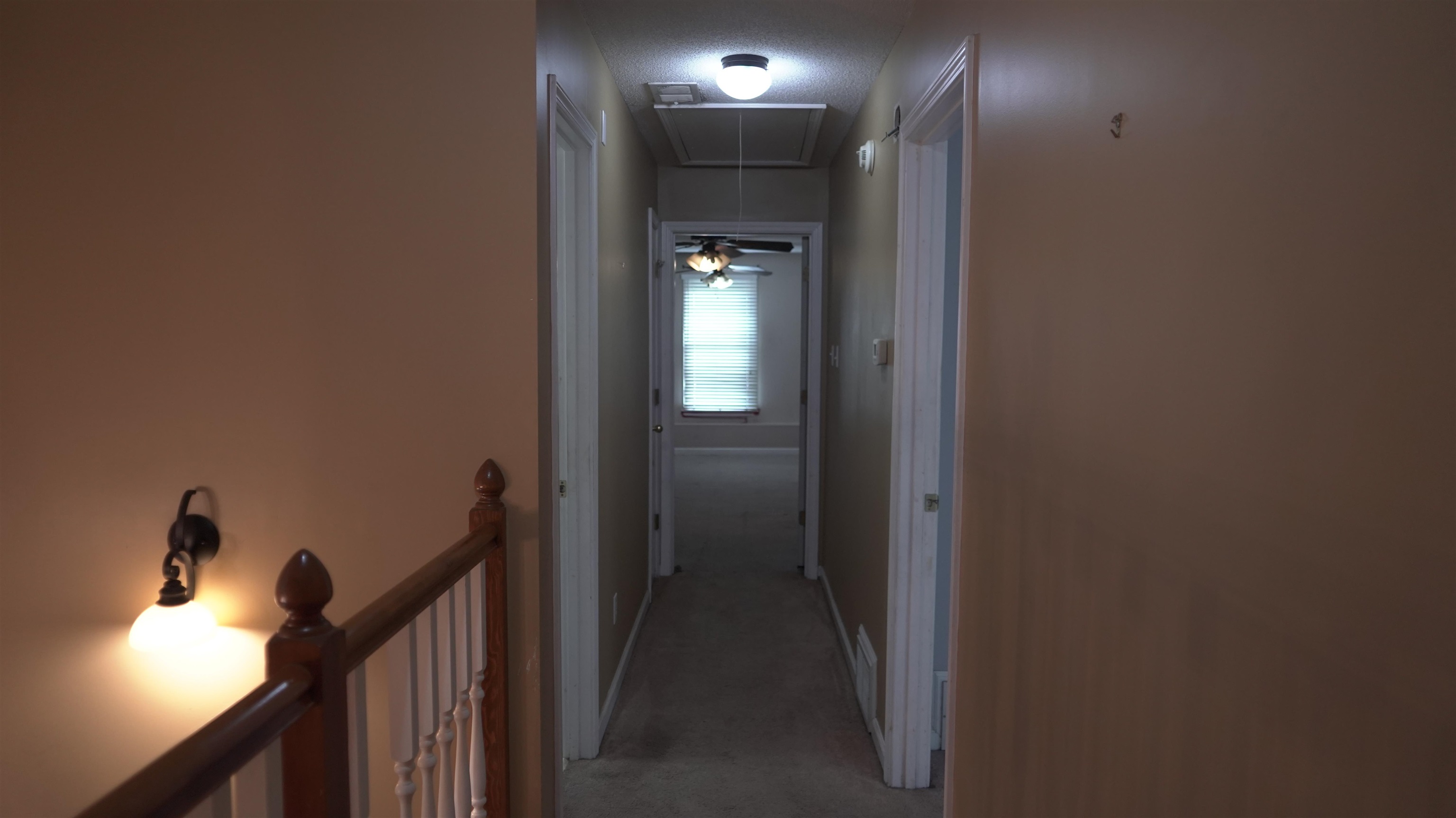 3717 Meade Lake Road Millington, TN 38053 - Photo 12 of 16 Corridor featuring light carpet and an upstairs landing