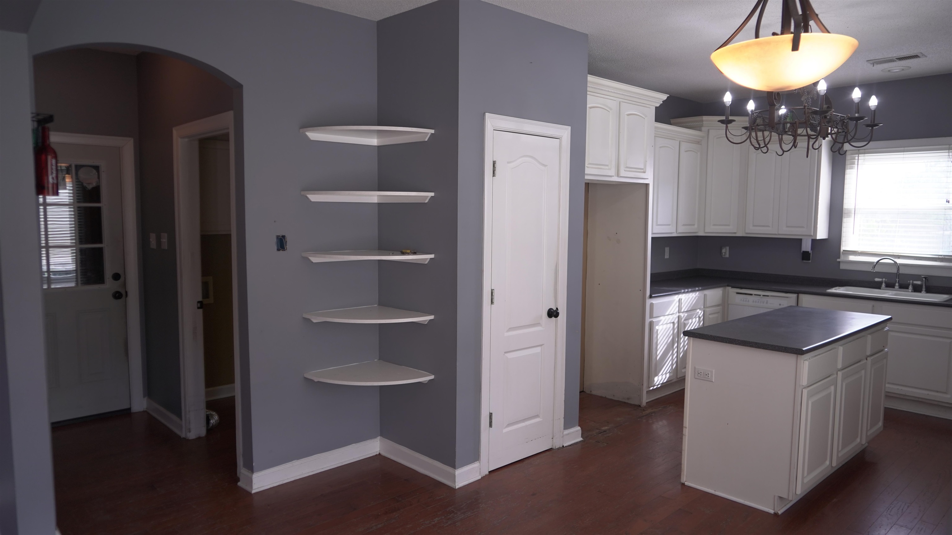 3717 Meade Lake Road Millington, TN 38053 - Photo 3 of 16 Kitchen featuring white cabinetry, suspended lighting, arched walkways, dark wood finished floors, and dark countertops
