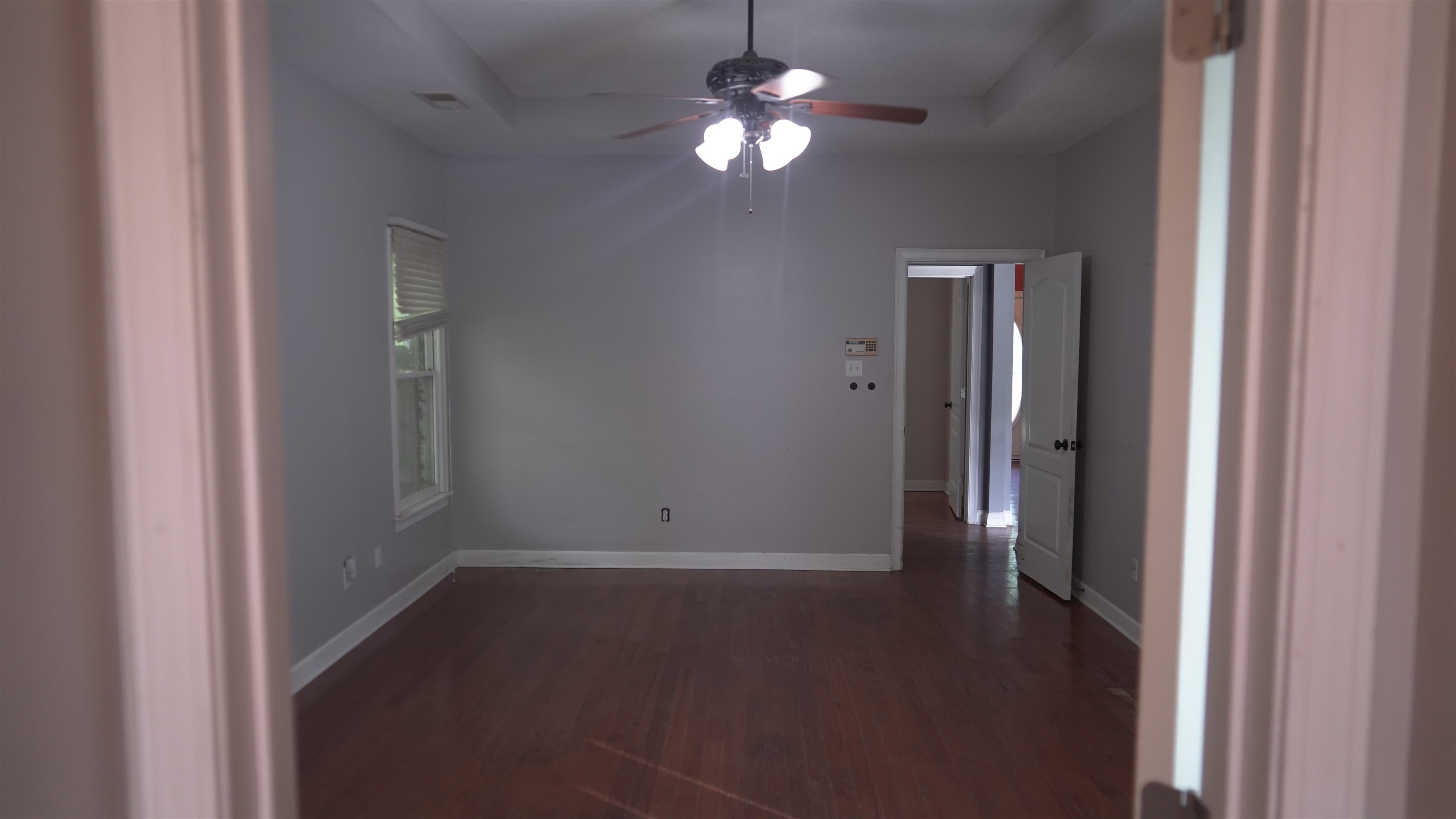 3717 Meade Lake Road Millington, TN 38053 - Photo 9 of 16 Empty room with ceiling fan and dark wood-style flooring