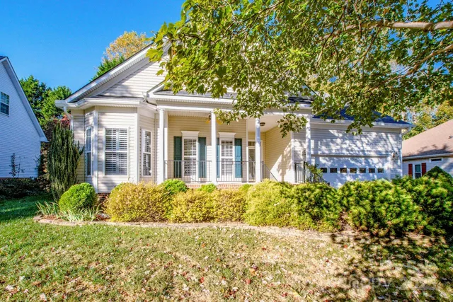 a view of a house with a small yard and plants