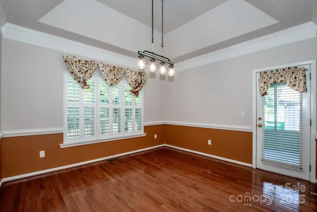 a view of room with window and wooden floor