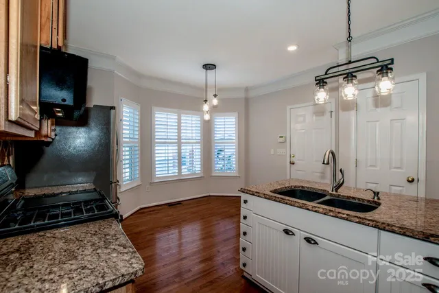 a kitchen with sink stove and refrigerator