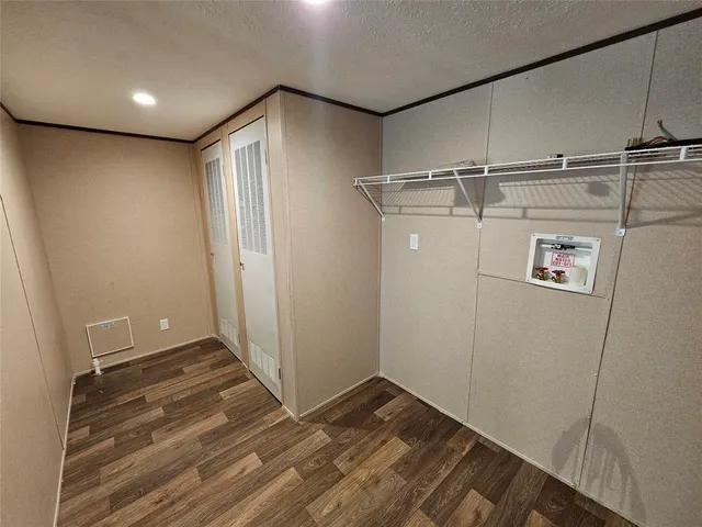 a view of a room with wooden floor