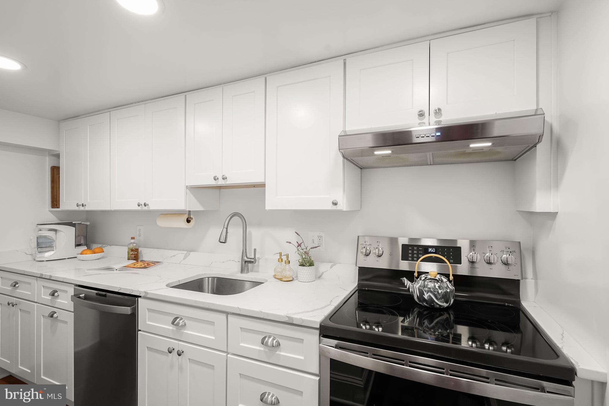 408 Seward Square Southeast, Unit 1 Washington, DC 20003 - Photo 11 of 21 a kitchen with stainless steel appliances granite countertop a sink stove and cabinets