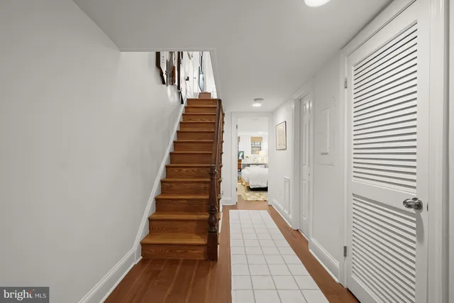 a view of a hallway with wooden floor and entryway
