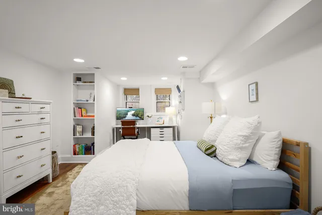 a bed room with a bed and a television