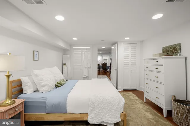 a bedroom with a bed and a mirror