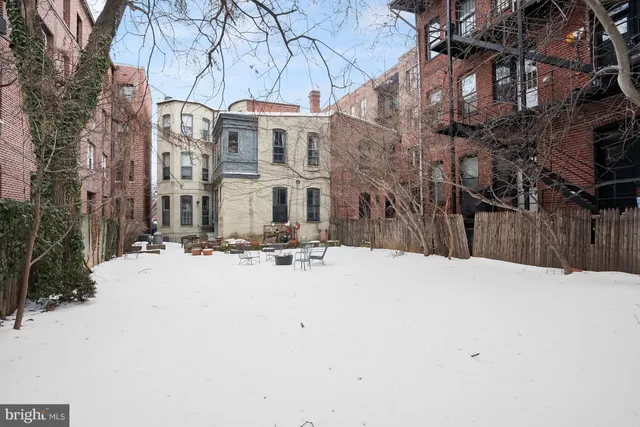 a view of a building with snow on the road