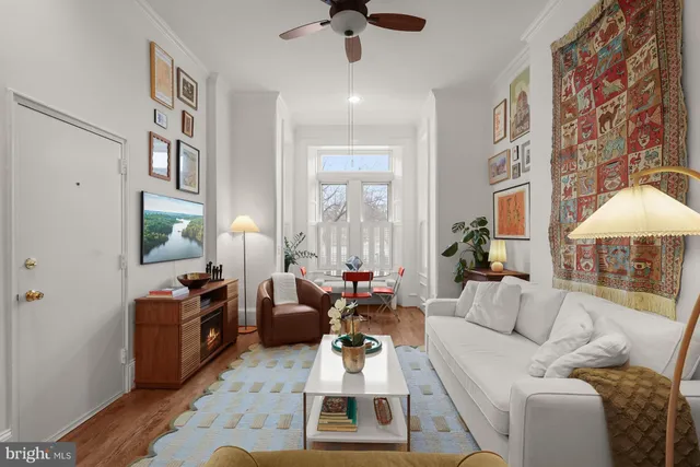 a living room with furniture or couch and a chandelier