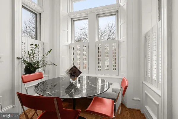 a view of a dining room with furniture and a window