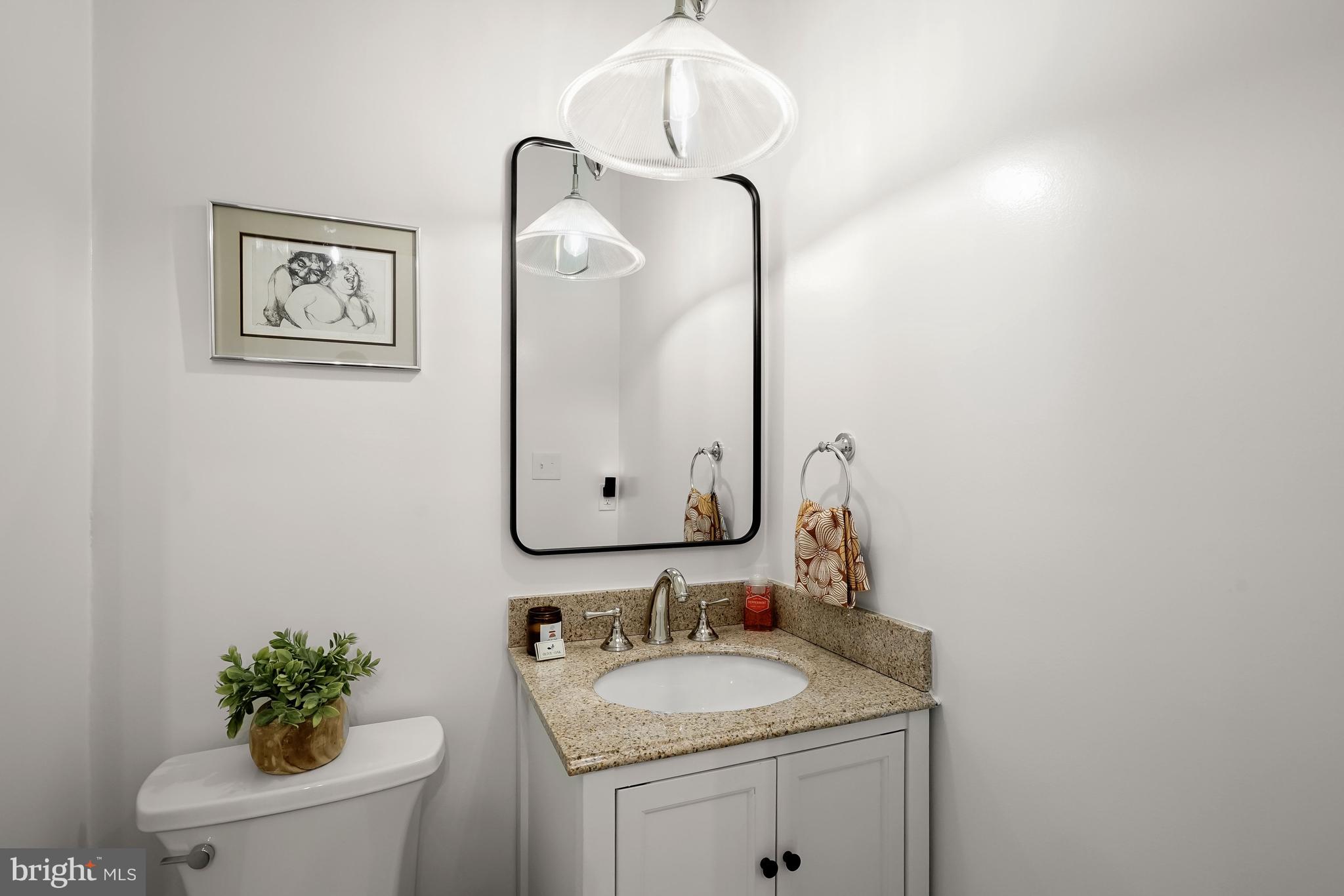408 Seward Square Southeast, Unit 1 Washington, DC 20003 - Photo 8 of 21 a bathroom with a granite countertop sink and a mirror