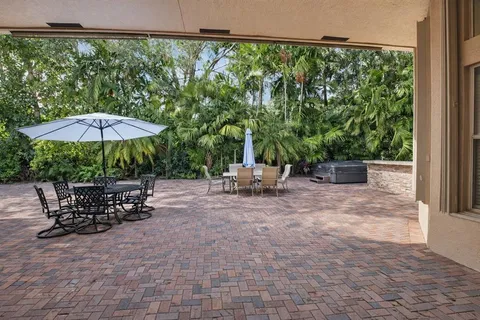 an aerial view of house with yard and ocean view