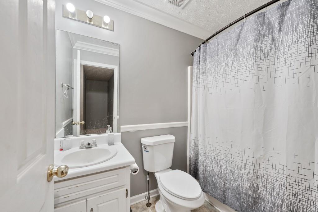 160 Azalea Drive Winder, GA 30680 - Photo 18 of 32 a bathroom with a toilet a sink and a mirror