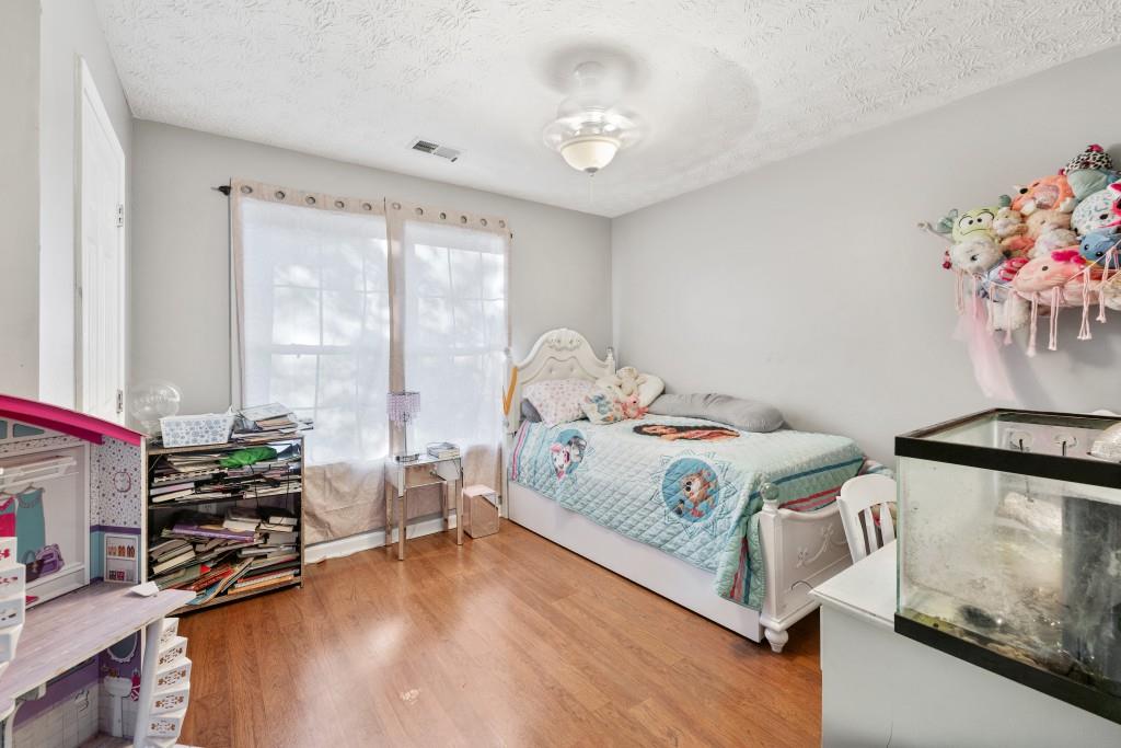 160 Azalea Drive Winder, GA 30680 - Photo 19 of 32 a bedroom with a bed and a chandelier