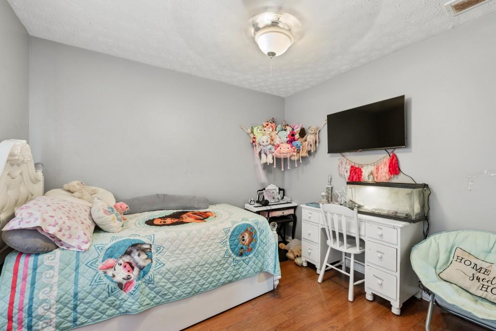 160 Azalea Drive Winder, GA 30680 - Photo 20 of 32 a bedroom with a bed and a flat screen tv