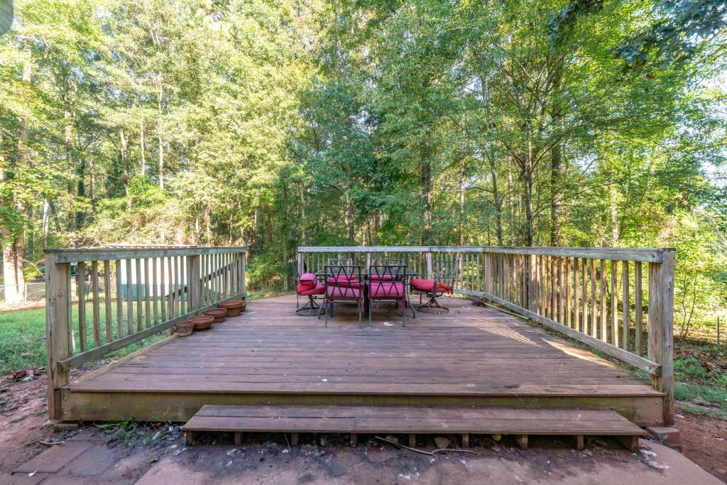 160 Azalea Drive Winder, GA 30680 - Photo 22 of 32 a view of a wooden deck with a bench