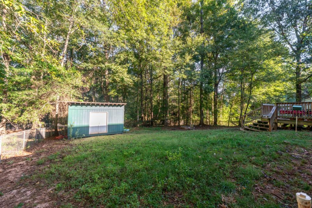 160 Azalea Drive Winder, GA 30680 - Photo 25 of 32 a front view of a house with a garden and trees