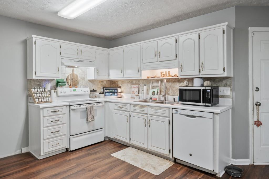 160 Azalea Drive Winder, GA 30680 - Photo 7 of 32 a kitchen with cabinets appliances a sink and a window