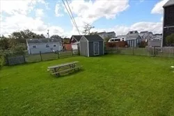 a view of a barn in the middle of a field