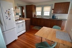 23 Everson Road, Unit 23 Marshfield, MA 02050 - Photo 6 of 6 a kitchen with stainless steel appliances wooden floor sink and wooden cabinets