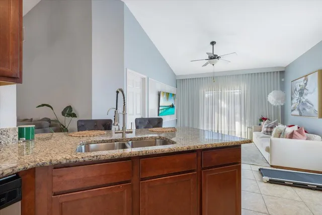 a kitchen with kitchen island granite countertop sink and cabinets
