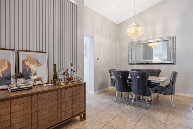 a room with table chairs and painting on the wall