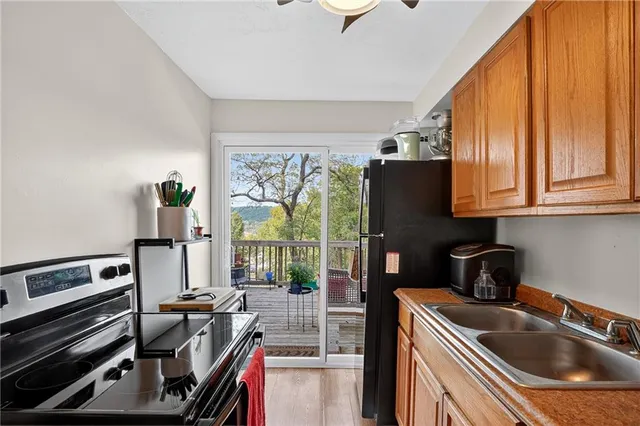 a kitchen with a stove a sink and a refrigerator