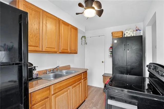 a kitchen with stainless steel appliances granite countertop a sink a stove and a refrigerator