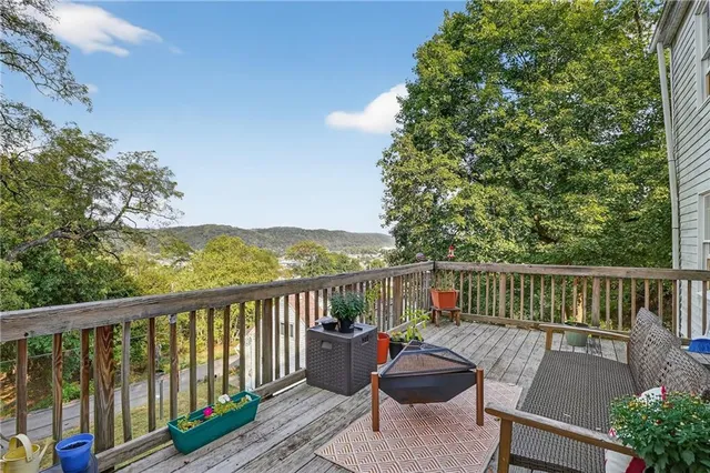 a view of a balcony with wooden floor and outdoor space