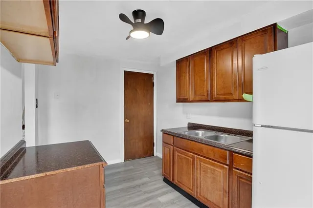 a kitchen with stainless steel appliances granite countertop cabinets and wooden floor