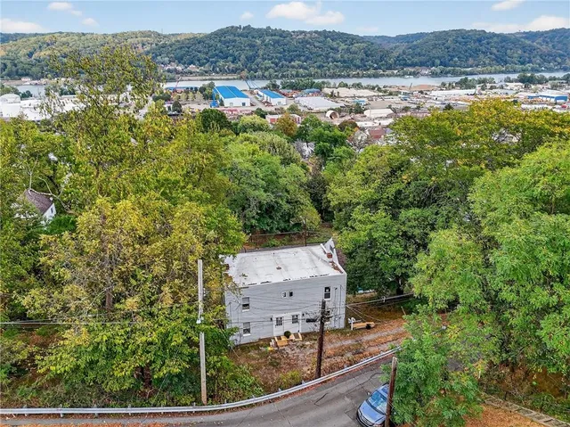 an aerial view of residential houses with outdoor space and swimming pool