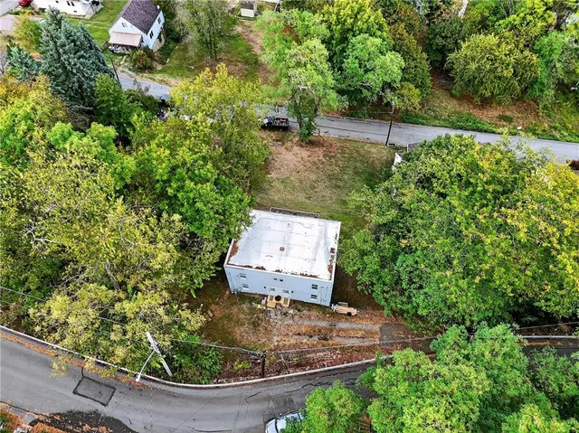 an aerial view of a house with a yard