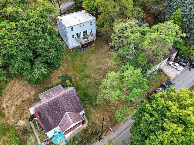 an aerial view of a house with garden space and street view
