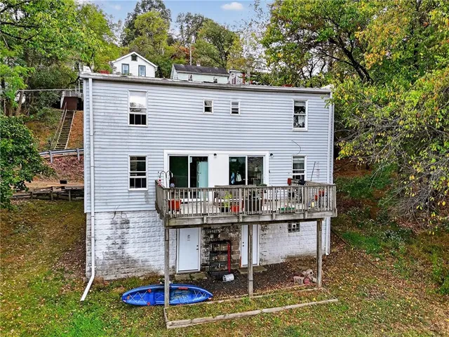 a view of a house with patio chairs and potted plants
