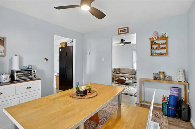 a kitchen with a stove a refrigerator and a dining table