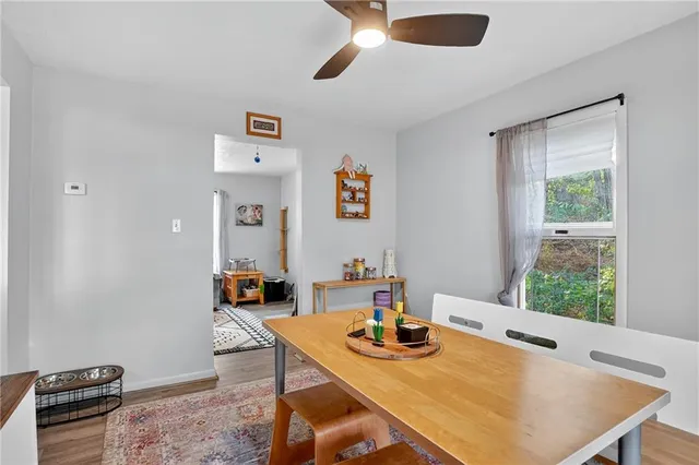 a view of a dining room with furniture and a window