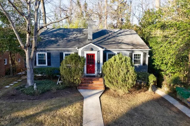 a view of a house with pool and garden