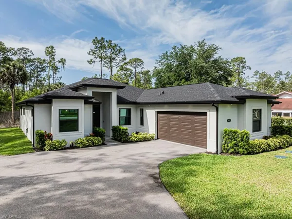 a front view of a house with a garden