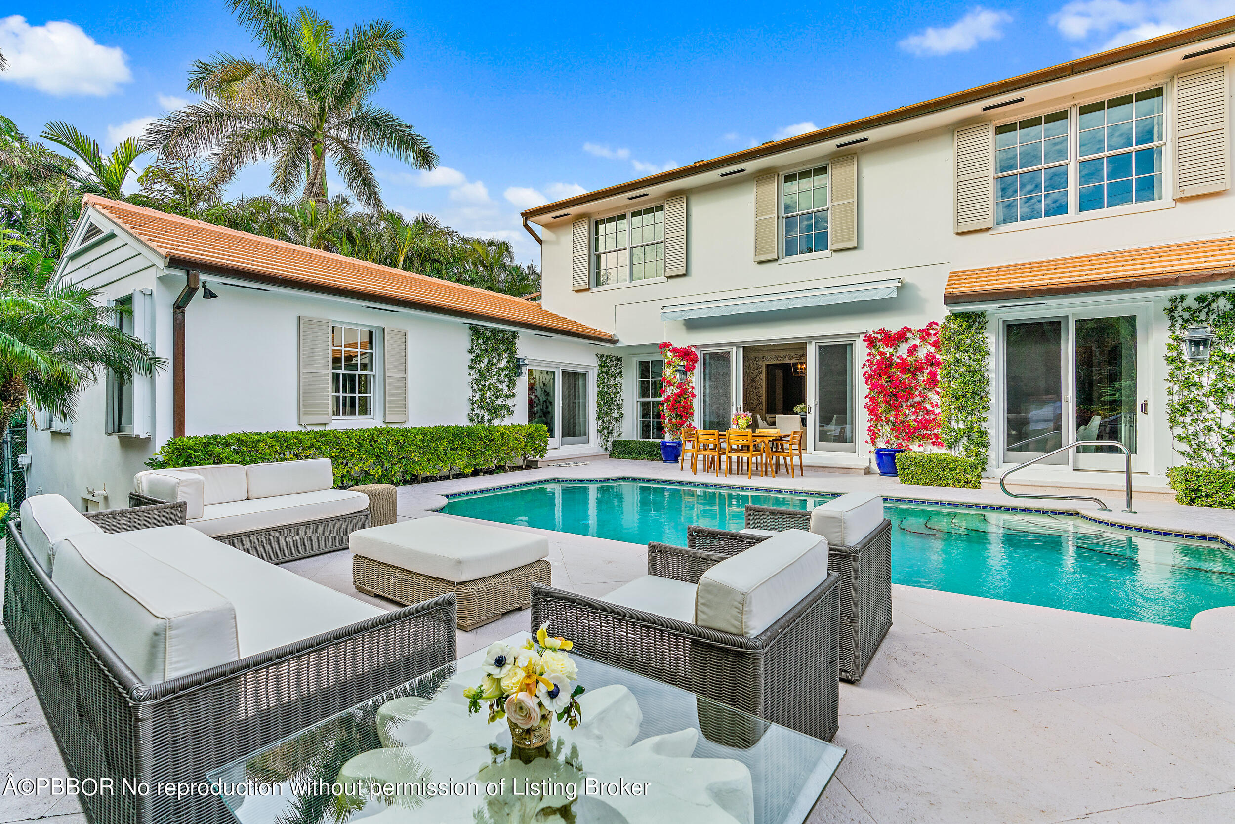 a view of a house with swimming pool and furniture
