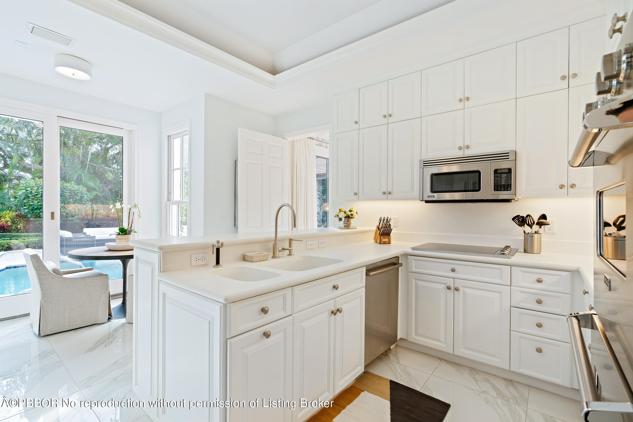 310 Plantation Road Palm Beach, FL 33480 - Photo 14 of 38 a kitchen with a sink stove and cabinets