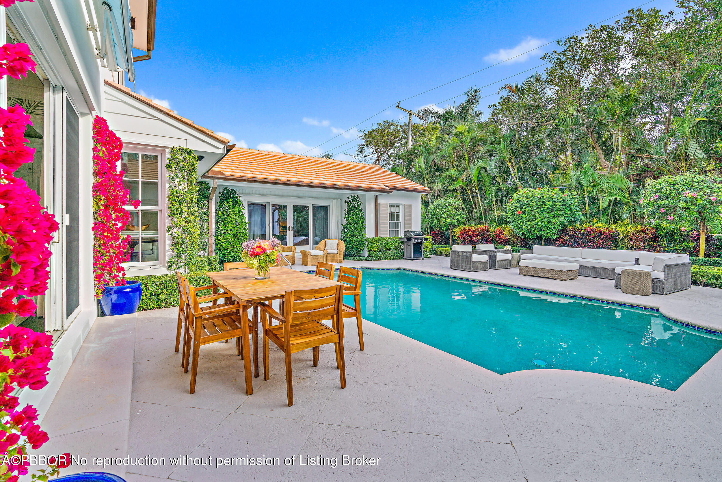310 Plantation Road Palm Beach, FL 33480 - Photo 4 of 38 a patio with a table and chairs and potted plants