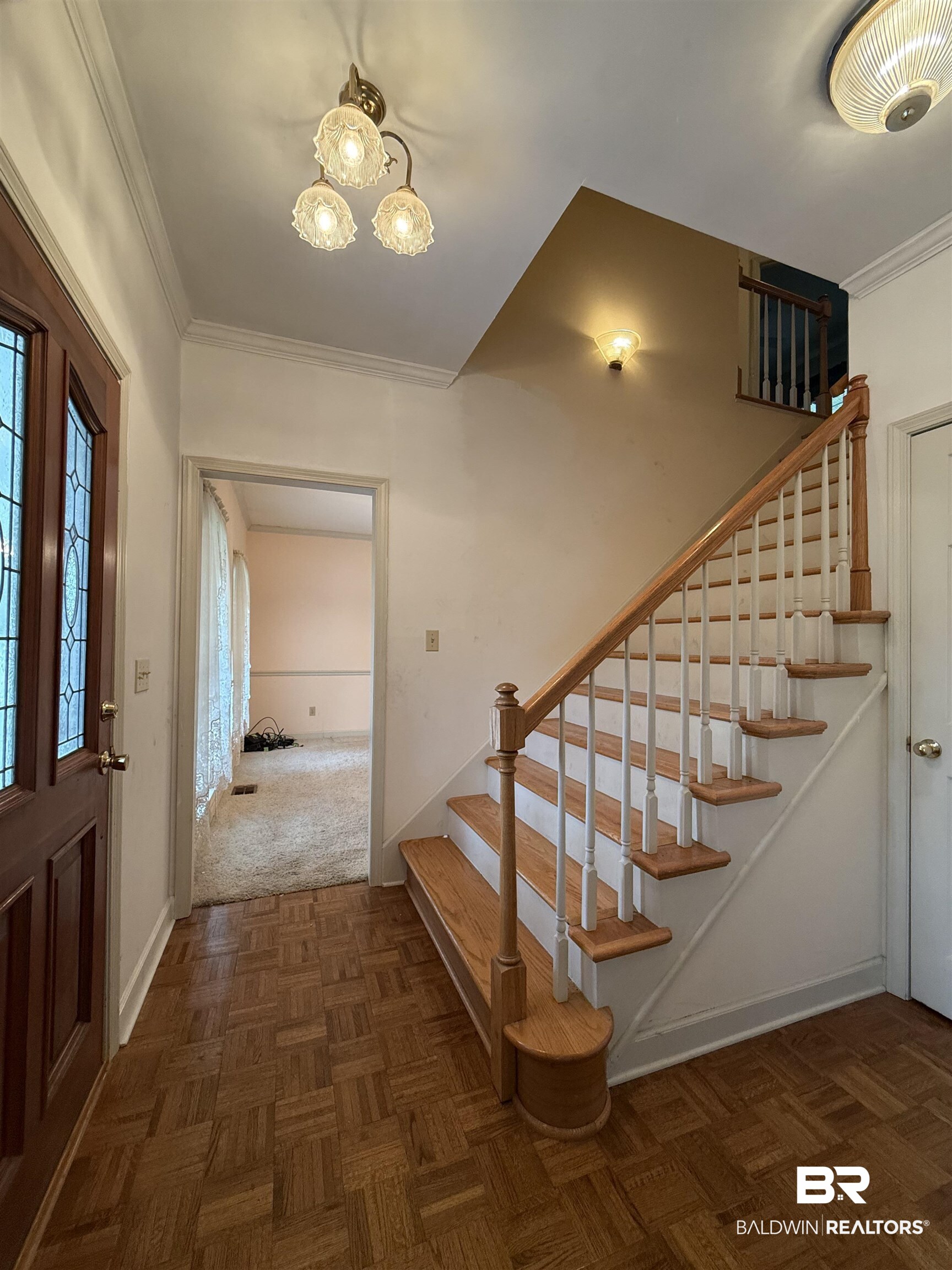 295 Norwood Road Monroeville, AL 36460 - Photo 14 of 32 Entrance foyer featuring stairs, a chandelier, ornamental molding, and baseboards
