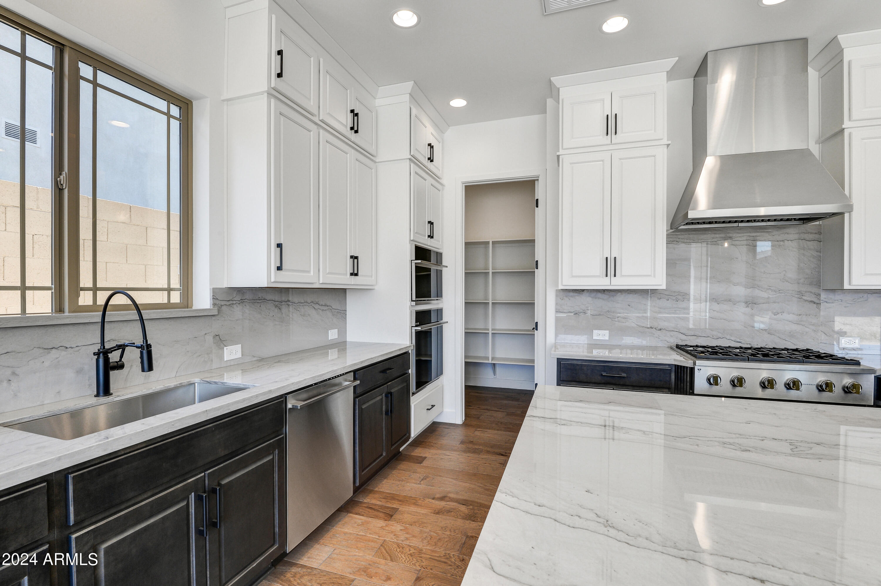 20717 West Rattler Road Buckeye, AZ 85396 - Photo 11 of 30 a kitchen with stainless steel appliances granite countertop a sink a stove and a refrigerator