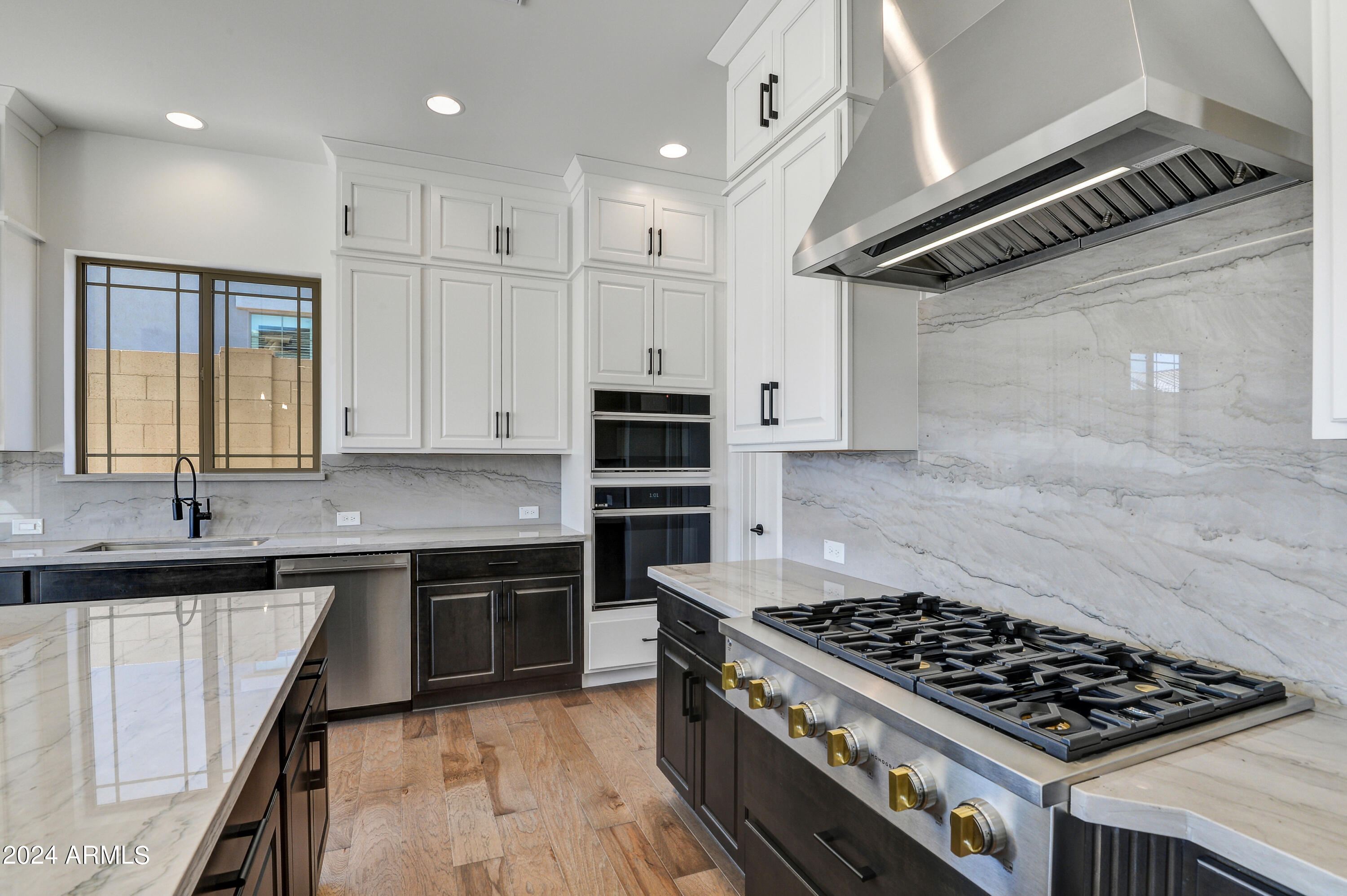 20717 West Rattler Road Buckeye, AZ 85396 - Photo 12 of 30 a kitchen with stainless steel appliances granite countertop a stove a sink and a microwave