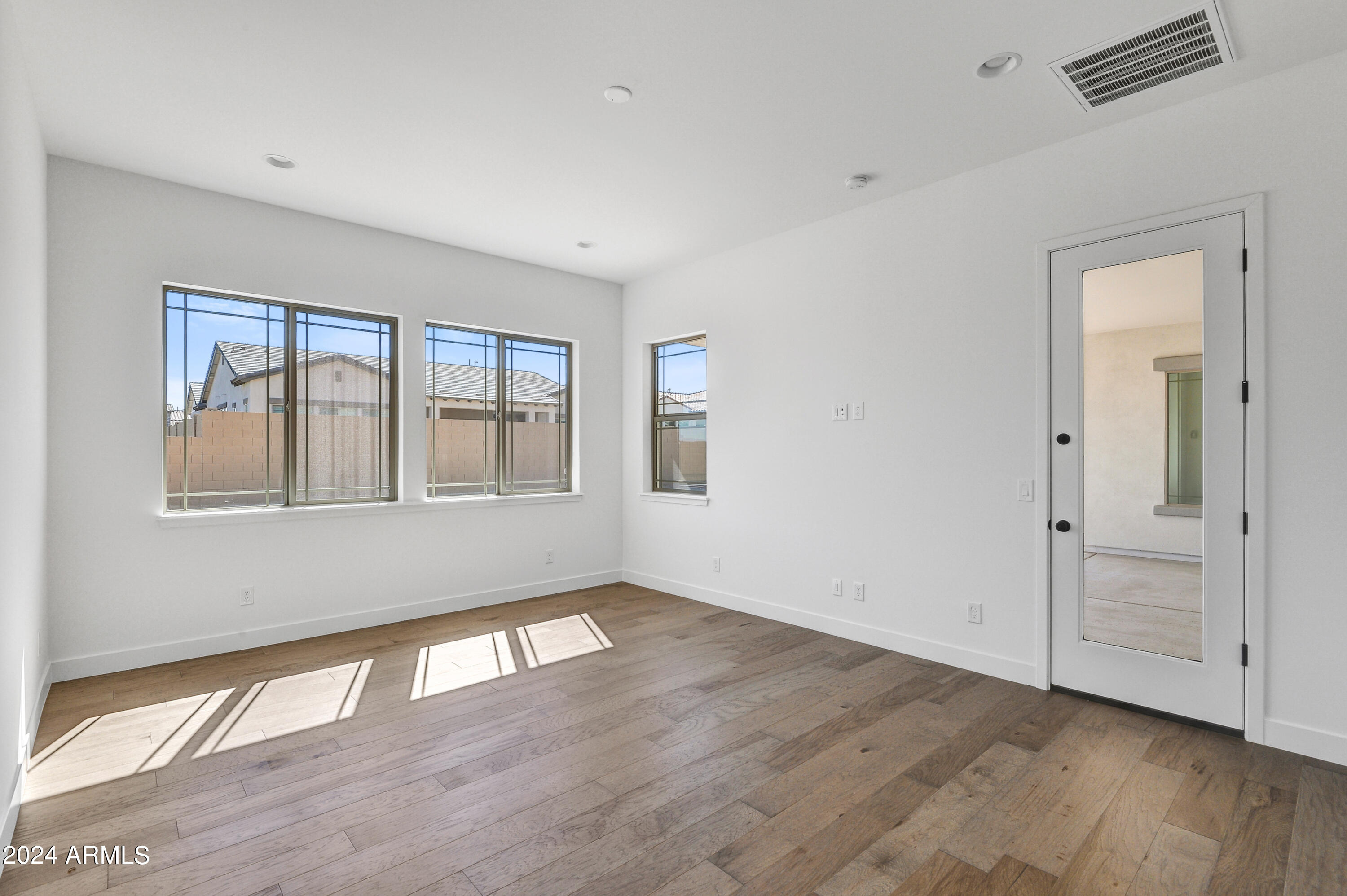 20717 West Rattler Road Buckeye, AZ 85396 - Photo 14 of 30 a view of empty room with wooden floor and fan