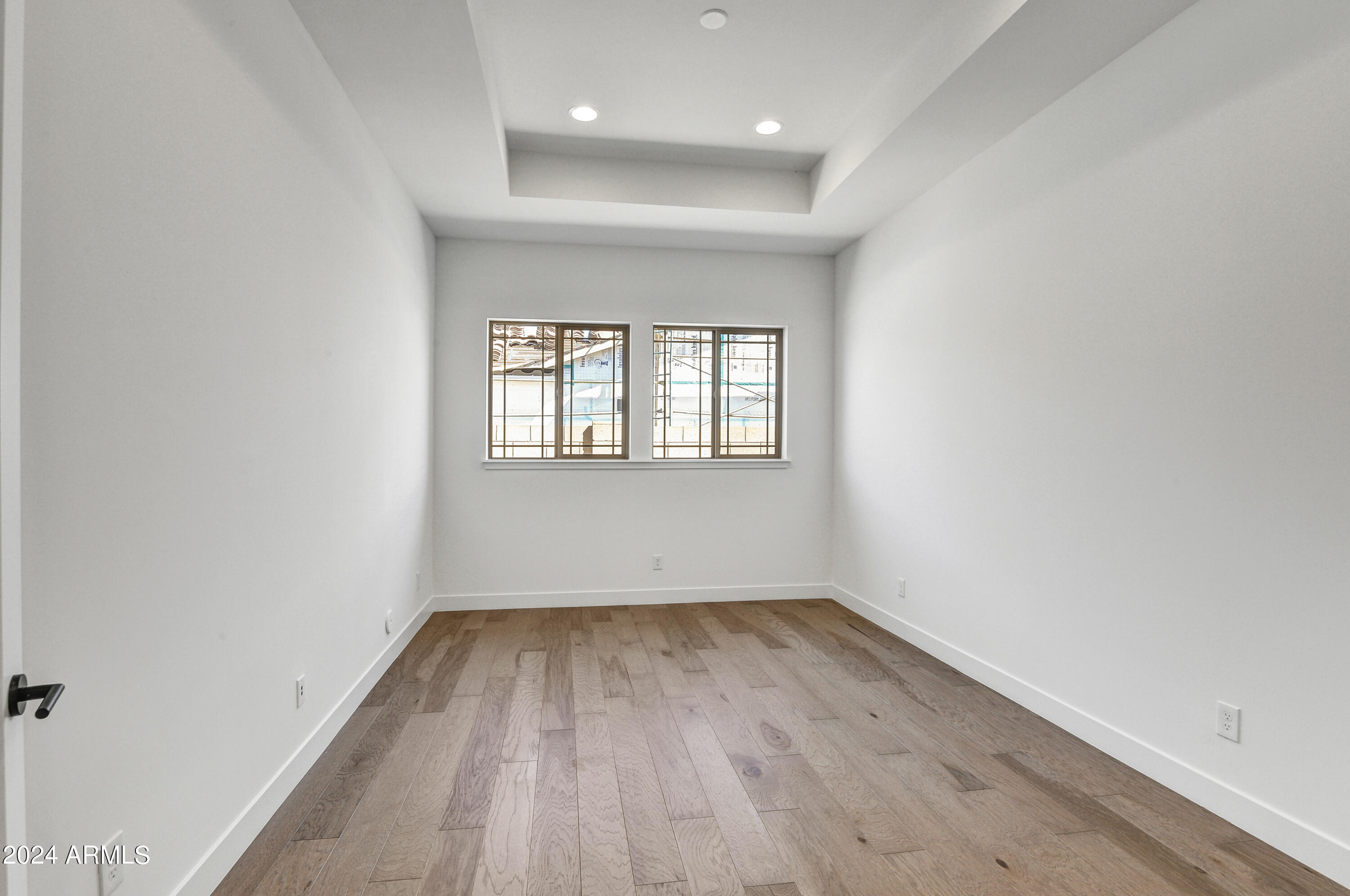 20717 West Rattler Road Buckeye, AZ 85396 - Photo 16 of 30 an empty room with wooden floor and windows
