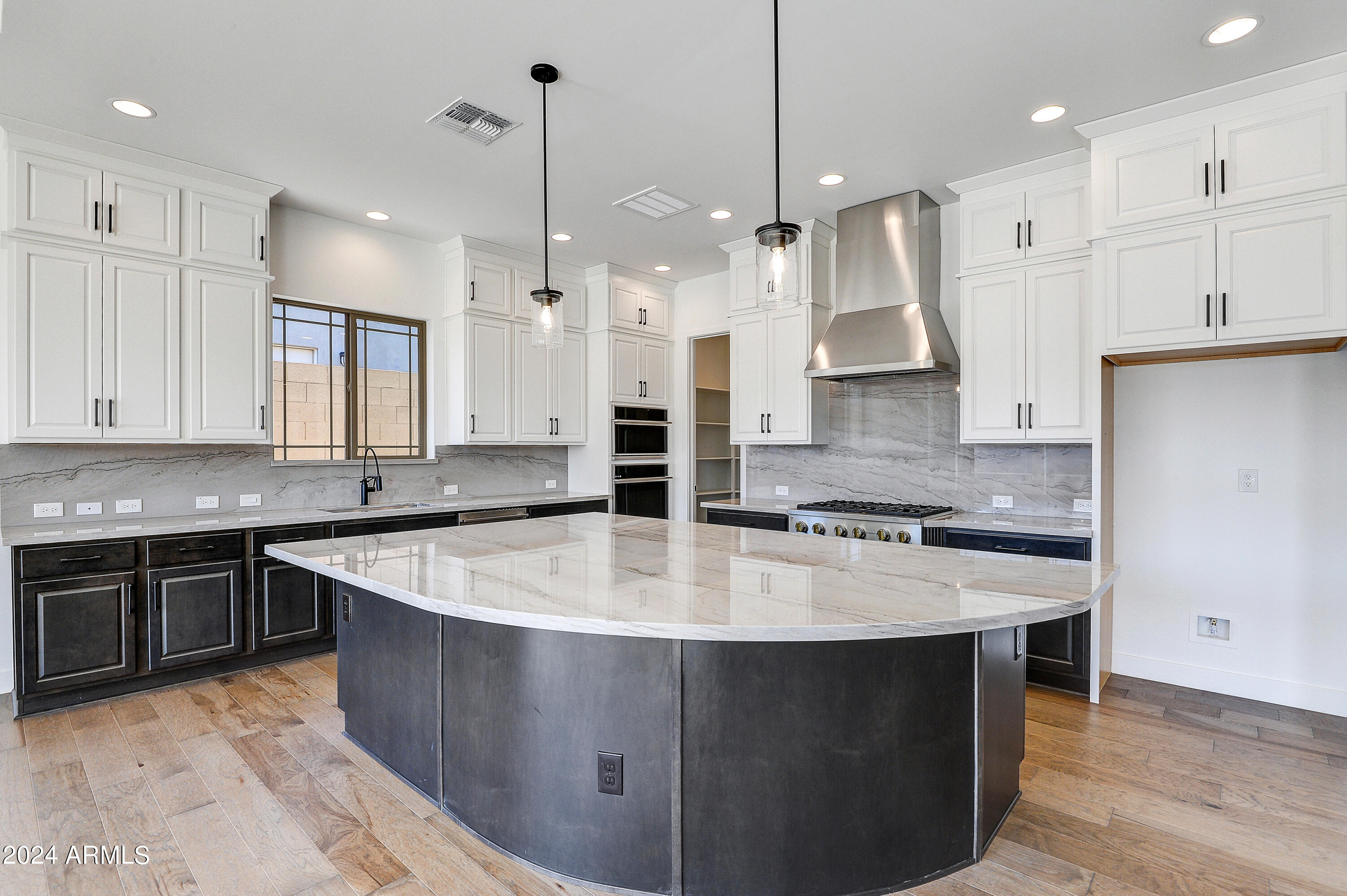 20717 West Rattler Road Buckeye, AZ 85396 - Photo 9 of 30 a large kitchen with stainless steel appliances granite countertop a sink a stove and a refrigerator