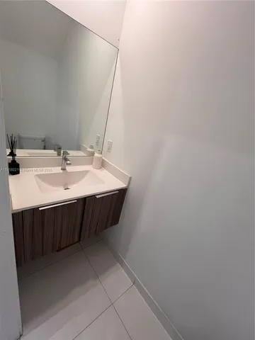 a white toilet sitting next to a white cabinet
