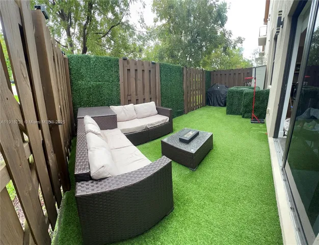 a view of backyard of house with outdoor seating